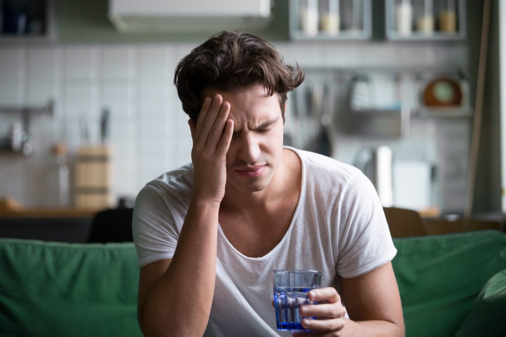 man suffering from migraine