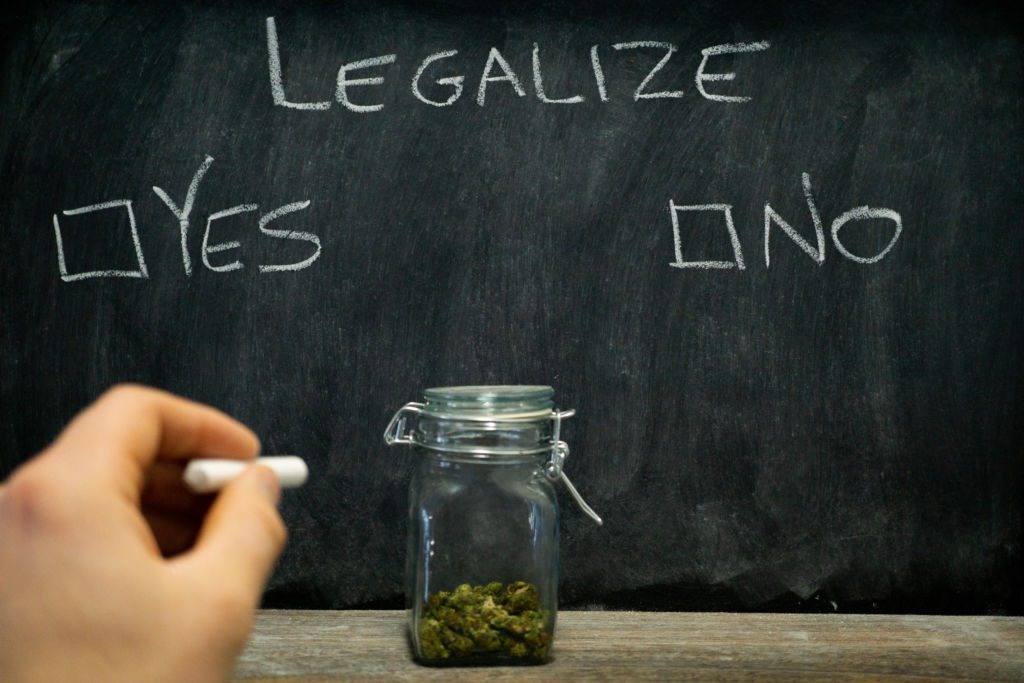 Legalization,Voting,On,The,Marijuana,Issue,,A,Hand,Reaching,Toward